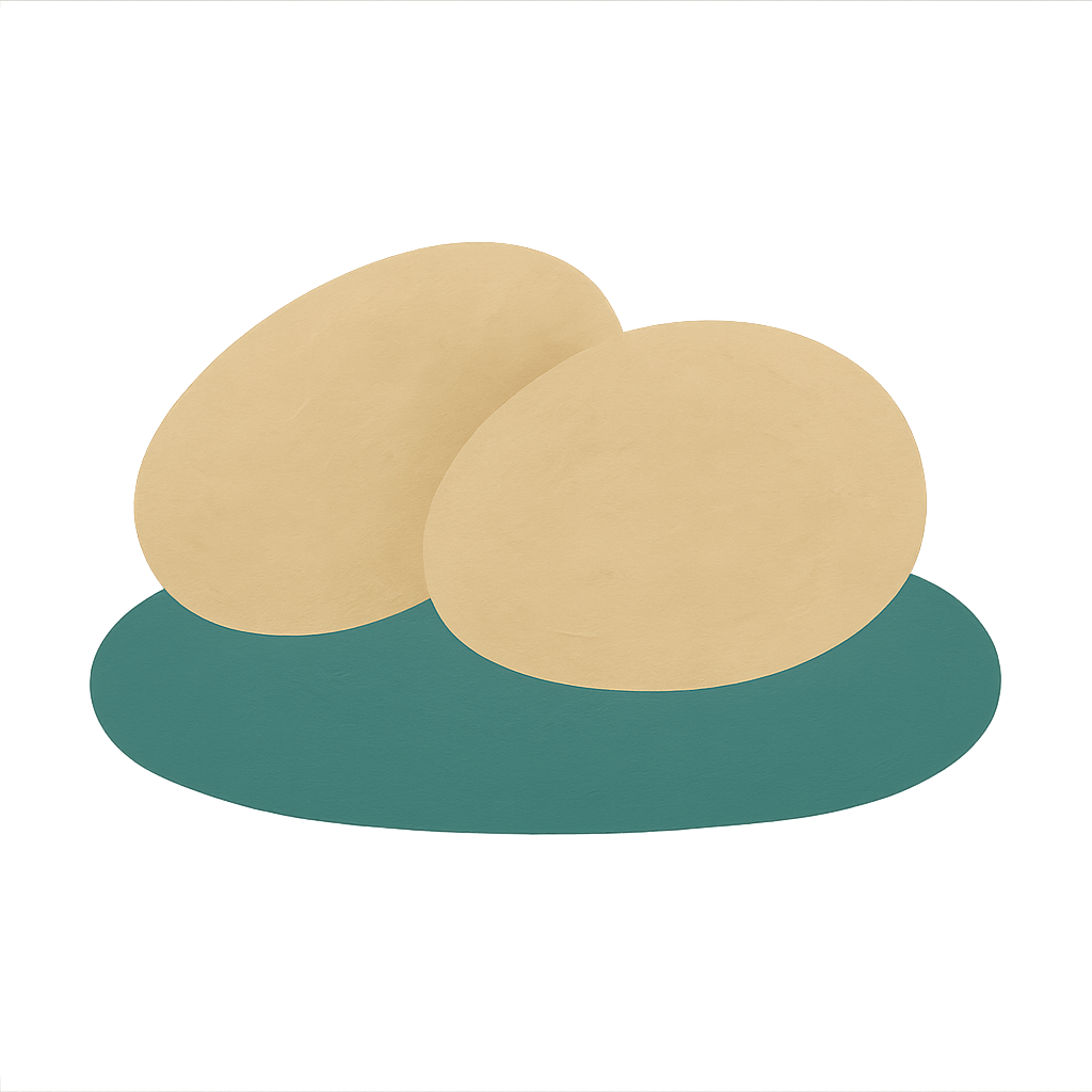 Two identical oat-coloured pebbles resting side by side on a jade base, one shape shown twice